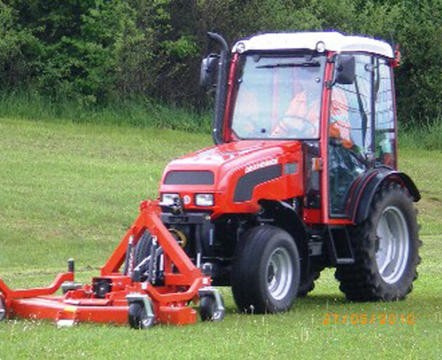 Dexheimer 509 mit Frontmulcher Traktor mit Frontmulcher bei Arbeitseinsatz auf Wiese